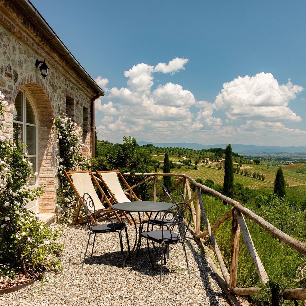 Tuscan villa terrace overlooking vineyards and rolling hills