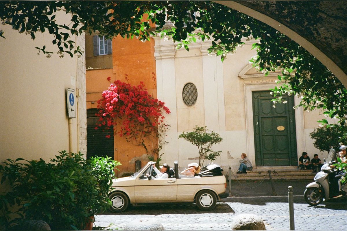 European street scene with white convertible and bougainvillea