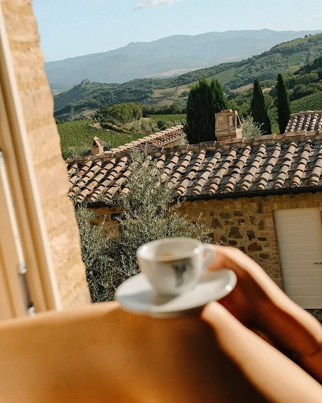 Tuscan rooftops with espresso in foreground